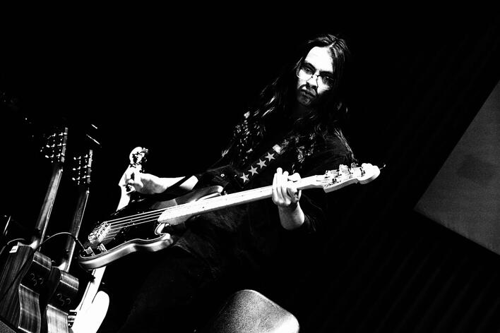 DRaineImage1 Photo from May-June 2024 of Raine playing bass on a live cover of "R U Mine" by Artic Monkeys